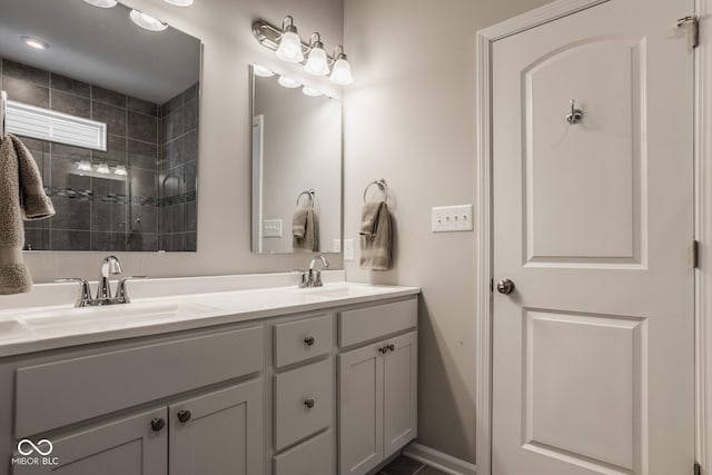 bathroom with vanity and tiled shower