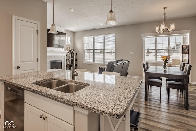 kitchen featuring sink, white cabinetry, and hanging light fixtures