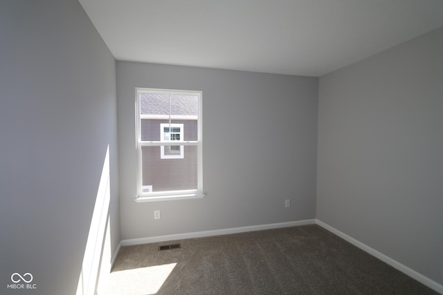 unfurnished room with visible vents, carpet flooring, and baseboards