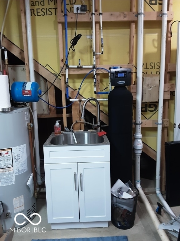 utility room featuring water heater