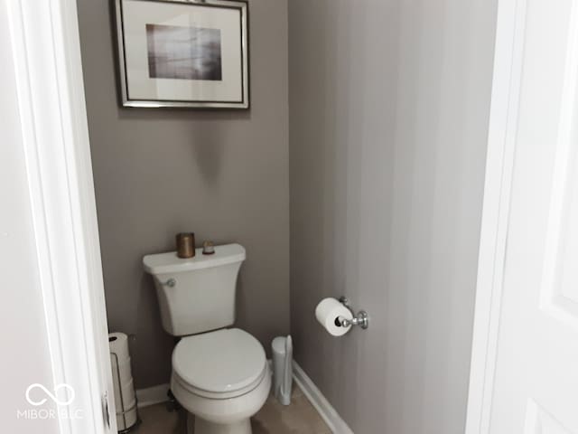 bathroom with toilet and tile patterned flooring