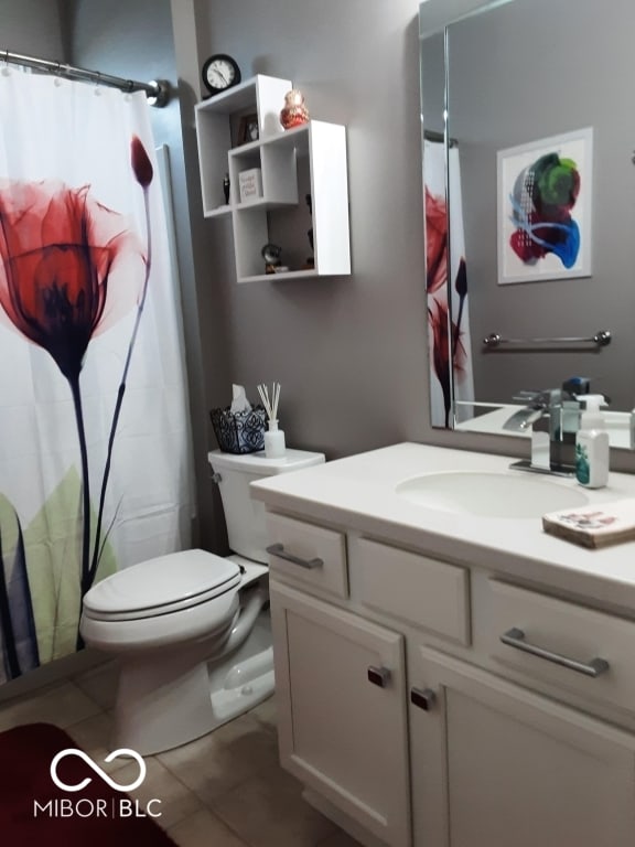 bathroom with vanity, tile patterned floors, and toilet