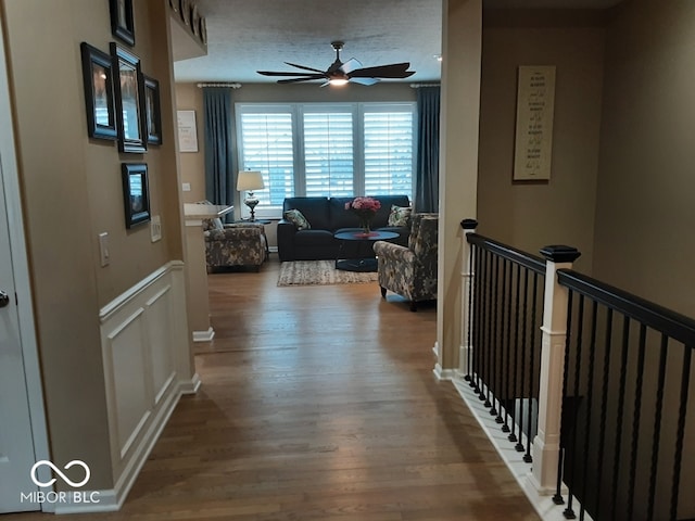 hall featuring hardwood / wood-style flooring and a textured ceiling