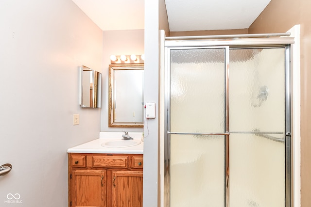 bathroom featuring walk in shower and vanity