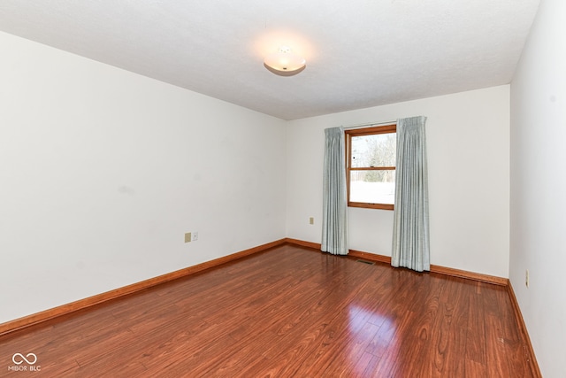 unfurnished room with dark hardwood / wood-style floors