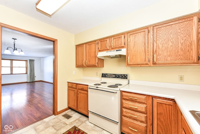 kitchen featuring electric stove, hanging light fixtures, and a notable chandelier