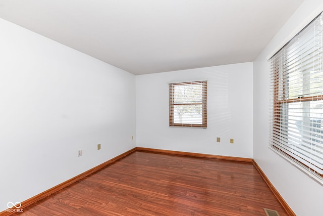 spare room with wood-type flooring