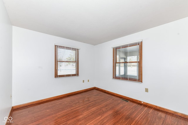 empty room with hardwood / wood-style flooring