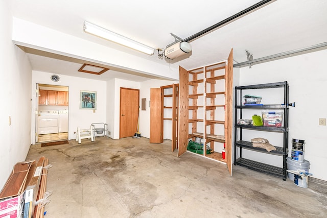 garage featuring washing machine and clothes dryer and a garage door opener