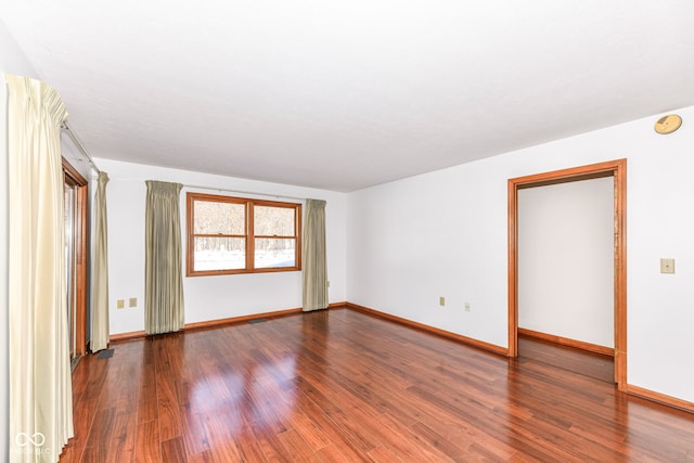 spare room with dark wood-type flooring