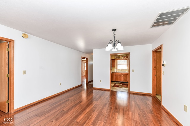 interior space featuring sink, dark hardwood / wood-style floors, and a chandelier