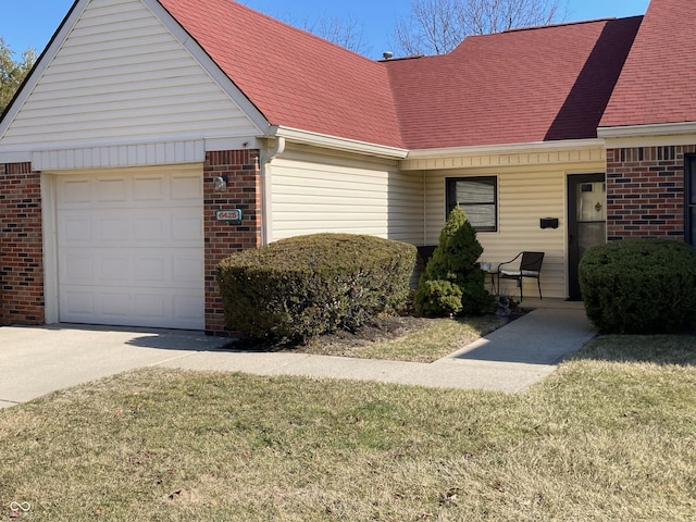 view of front of home with brick siding, roof with shingles, and an attached garage