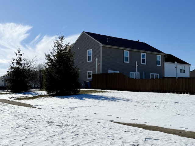 view of snow covered back of property