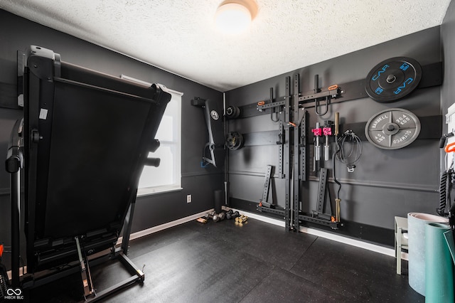 workout room with a textured ceiling