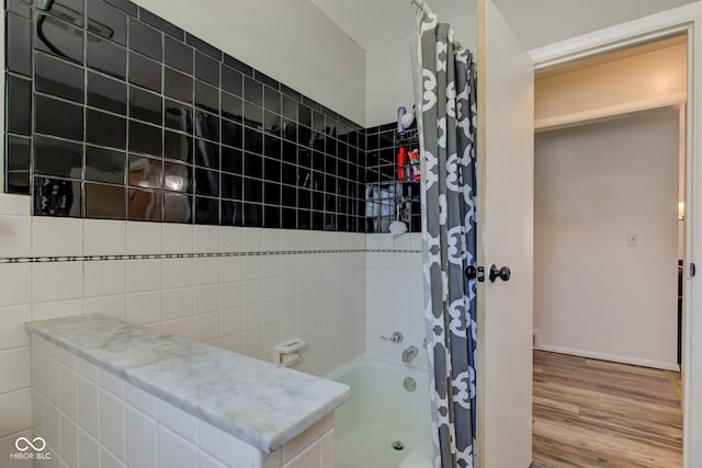 bathroom featuring hardwood / wood-style floors and shower / tub combo