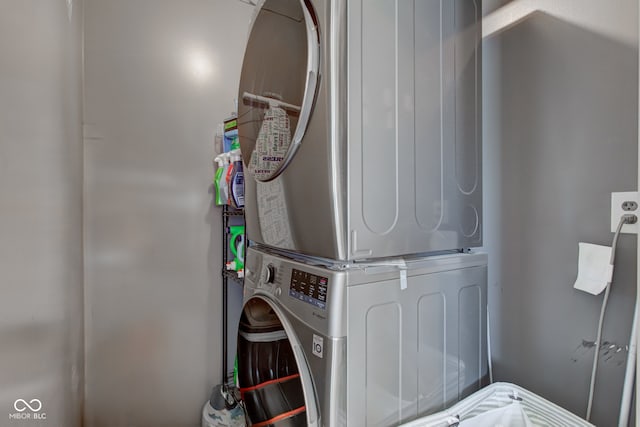 clothes washing area with stacked washer and dryer