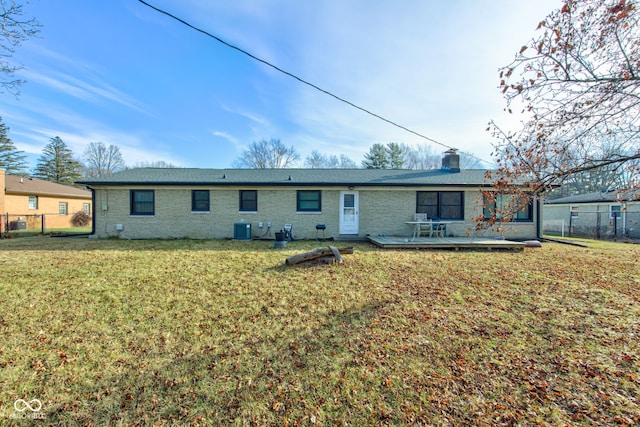 back of house with a lawn, cooling unit, and a deck