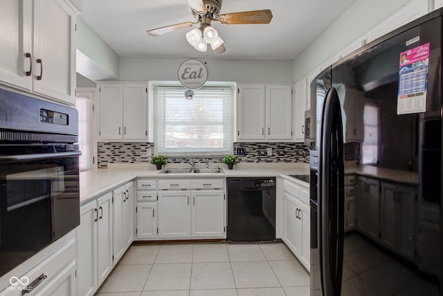 kitchen featuring white cabinets, decorative backsplash, sink, and black appliances