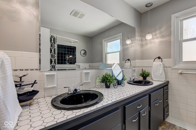 bathroom with vanity, hardwood / wood-style flooring, and tile walls