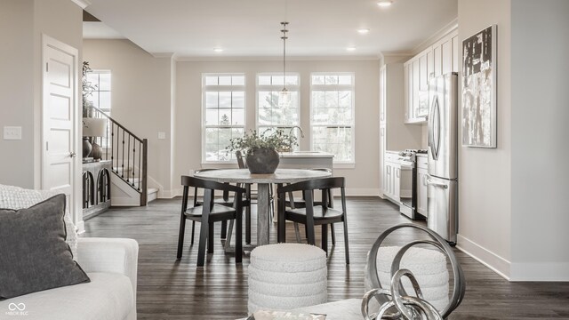 dining area featuring dark hardwood / wood-style flooring and ornamental molding