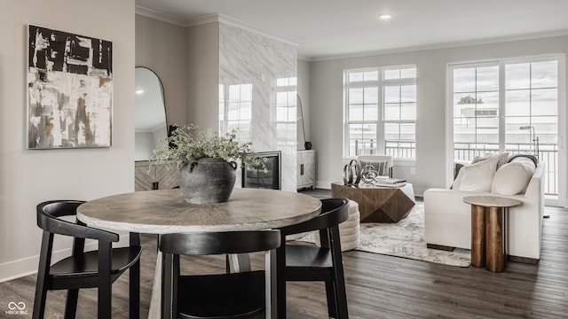 dining area featuring dark hardwood / wood-style flooring and ornamental molding