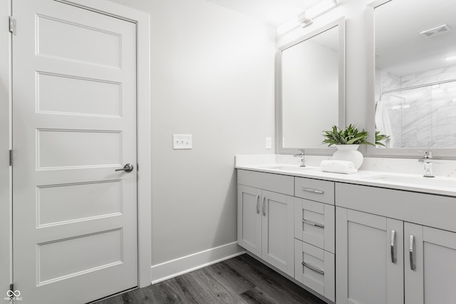 bathroom featuring a shower, wood-type flooring, and vanity