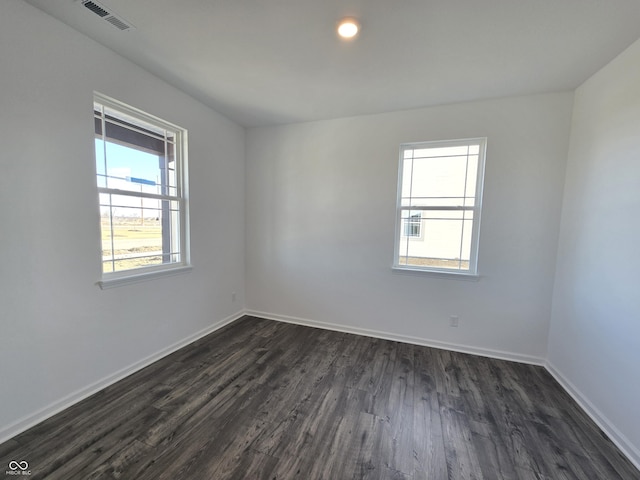 unfurnished room with dark hardwood / wood-style floors