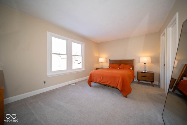 bedroom featuring light colored carpet