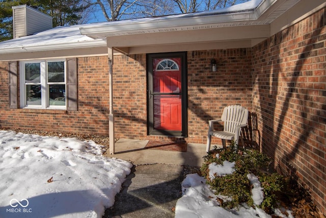 view of snow covered property entrance