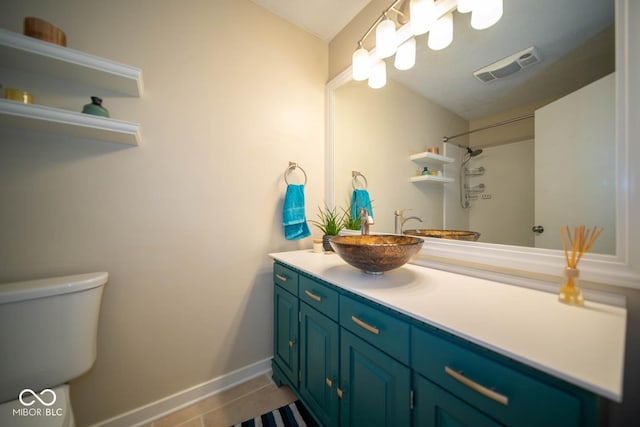 bathroom with toilet, tile patterned flooring, and vanity