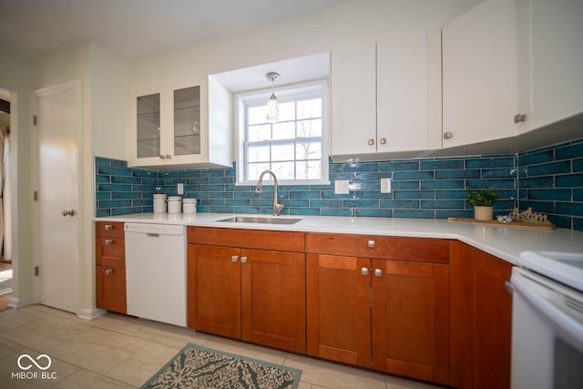 kitchen featuring white appliances, white cabinets, light tile patterned floors, and sink