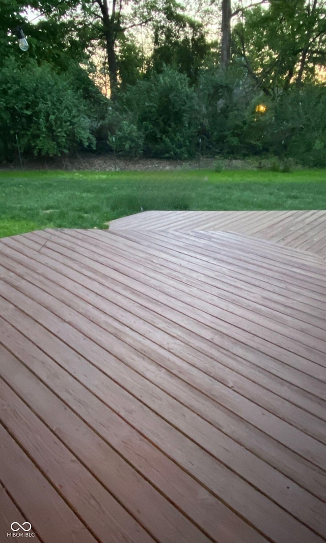 wooden deck with a lawn