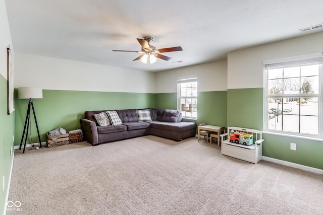 living room with ceiling fan and carpet flooring