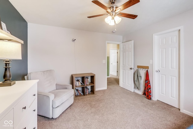 sitting room featuring ceiling fan and light carpet