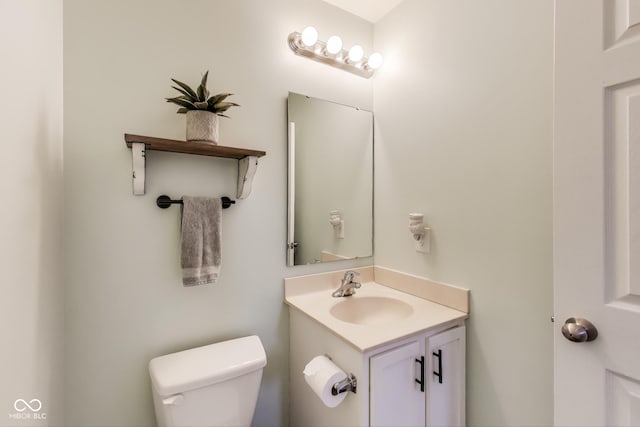 bathroom with toilet and vanity