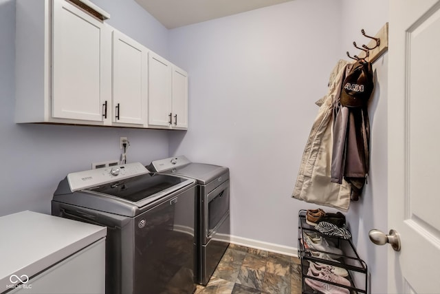 washroom with cabinets and washing machine and dryer