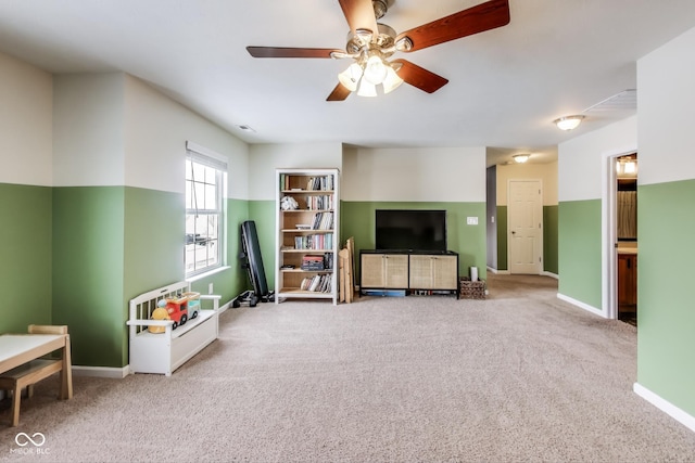 carpeted living room with ceiling fan