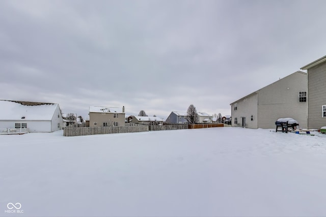 view of yard layered in snow