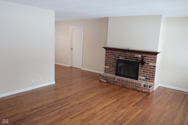 unfurnished living room with a fireplace and hardwood / wood-style flooring