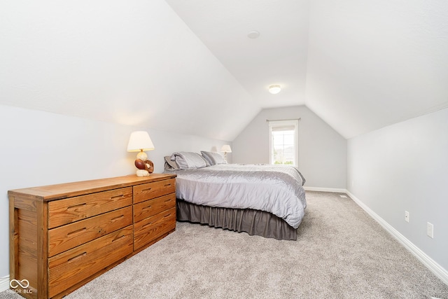 carpeted bedroom with lofted ceiling