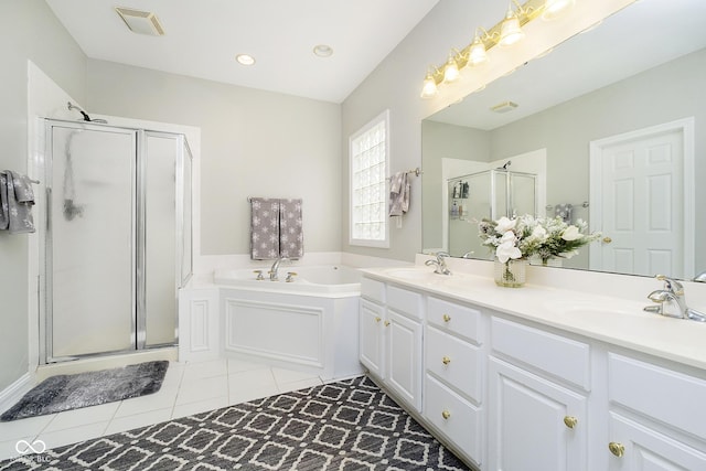 bathroom featuring tile patterned flooring, independent shower and bath, and vanity