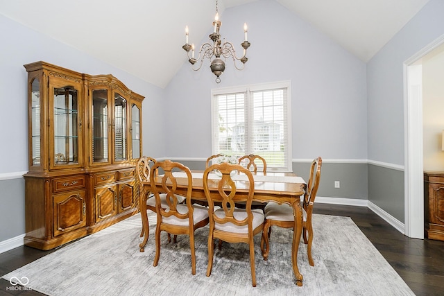 dining area featuring lofted ceiling, an inviting chandelier, and dark wood-type flooring