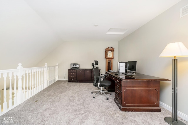 office space with vaulted ceiling and light colored carpet