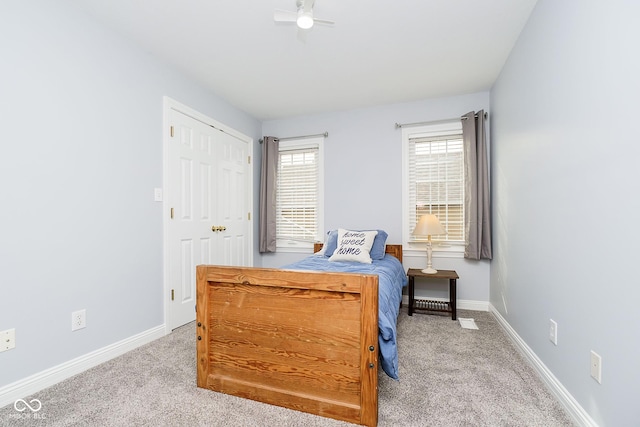 bedroom featuring ceiling fan, light colored carpet, and a closet