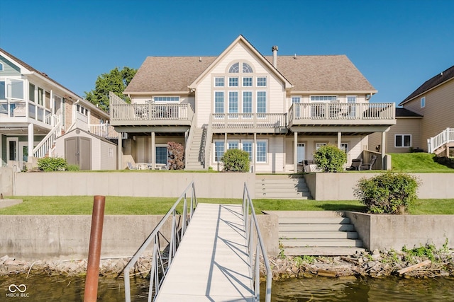 3150 Beach Blvd, Cicero, IN 46034 - rear view of house featuring stairs, a water view, and a lawn