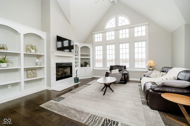 3150 Beach Blvd, Cicero, IN 46034 - living area with a tile fireplace, high vaulted ceiling, dark wood-style floors, built in shelves, and baseboards