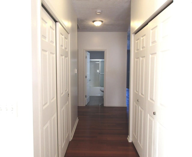 hall with dark hardwood / wood-style flooring