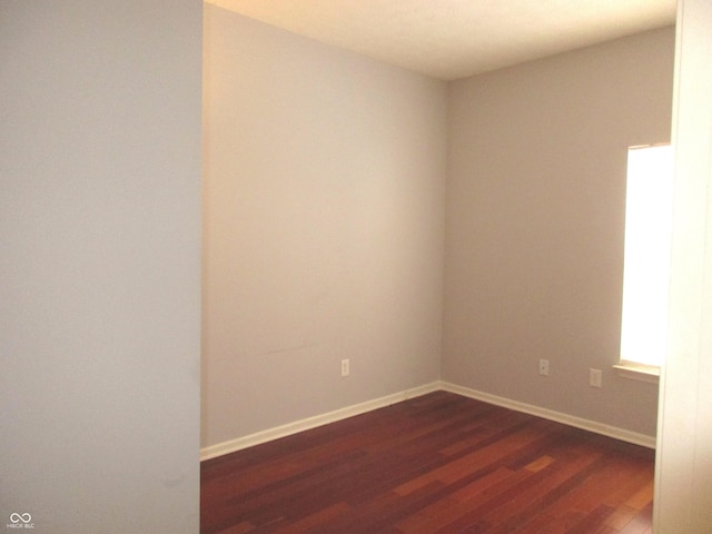 unfurnished room featuring dark hardwood / wood-style flooring