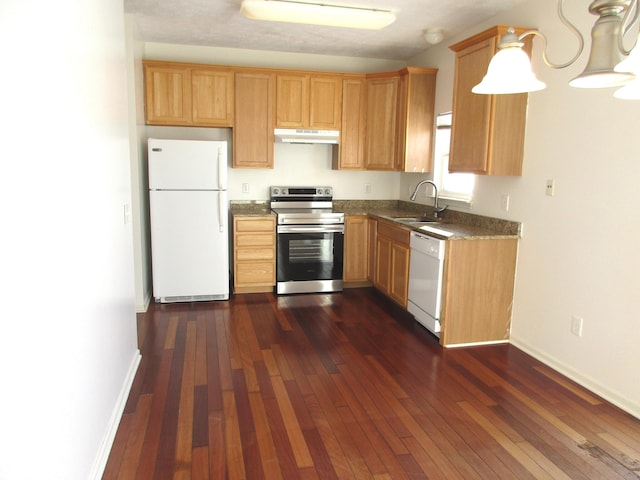 kitchen with dark hardwood / wood-style flooring, sink, and white appliances