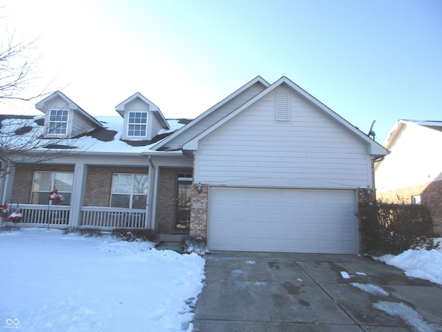 view of front of home featuring a porch and a garage